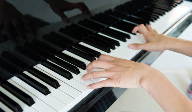 istock Woman hand playing the piano 1183045656