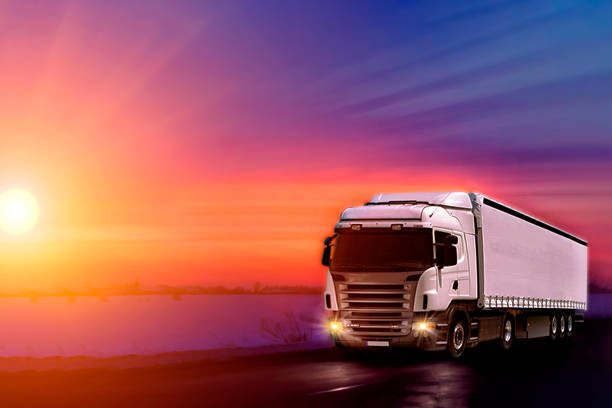 istock Truck with container on highway, cargo transportation concept. Sunset background with copy space 1183046625