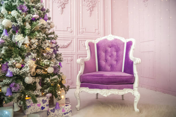 New Year's interior with purple sofa close-up and copy space. Living room with sofa and Christmas tree for neon colors.