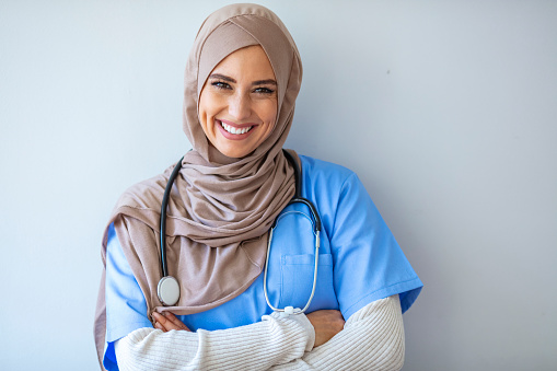 Confident Muslim female doctor standing inside hospital. Portrait of Muslim Doctor with stethoscope. Confident Muslim medical student pose at hospital. Confident Muslim doctor