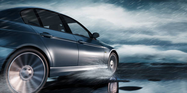 Luxury Car Outdoor Black Luxury Car driving through heavy Rain on empty Road auto racing photos stock pictures, royalty-free photos & images