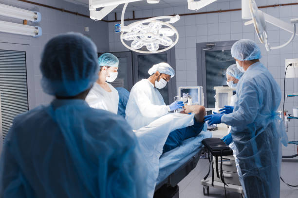 istock Medical Team Performing Surgical Operation in Bright Modern Operating Room 1183048889