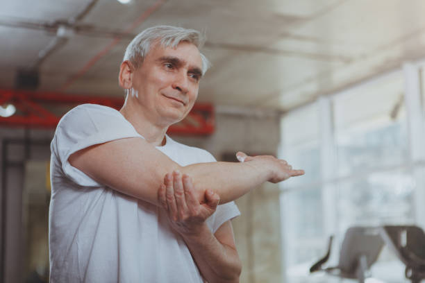 istock Senior man exercising at the gym 1183049389