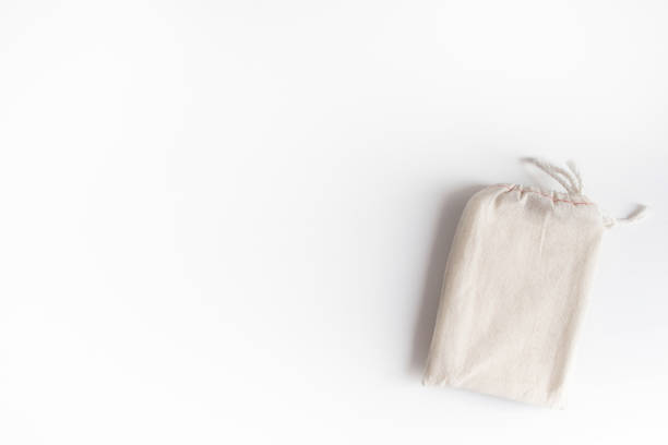 istock Mock up of tarot deck cotton bag with texture paper sheets on white background. Boho design of tarot cards pouch on white table with copy space for image or for text. 1183050723