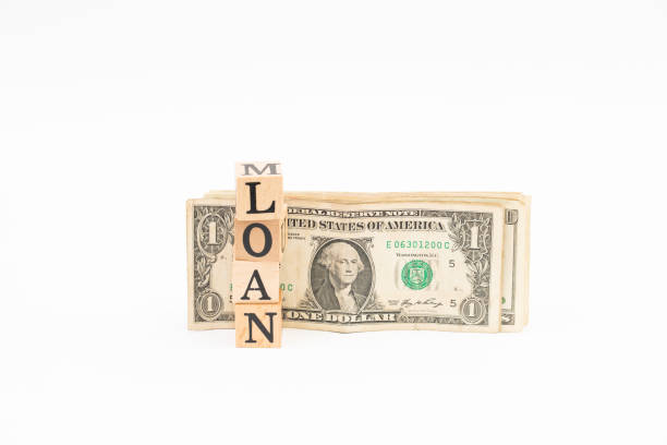 istock Wood block loan word with dollar banknote on white background. 1183051329