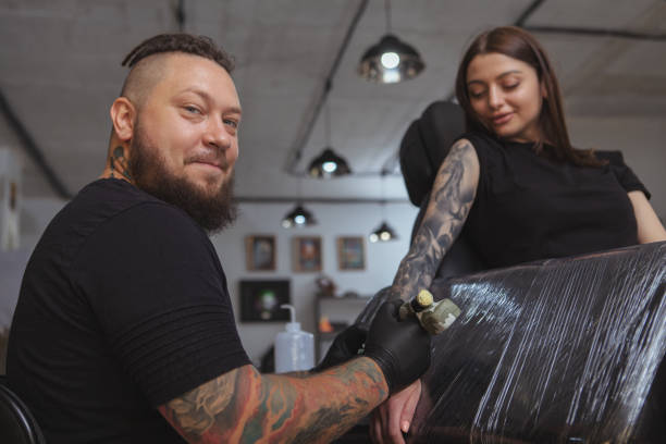 istock Professional tattoo artist working at his studio 1183052134