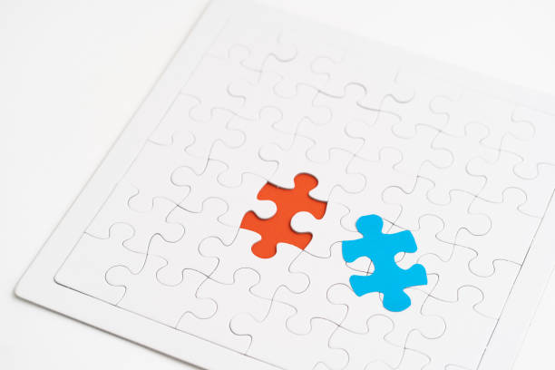 istock Blue jigsaw piece and red hold jigsaw 1183052188