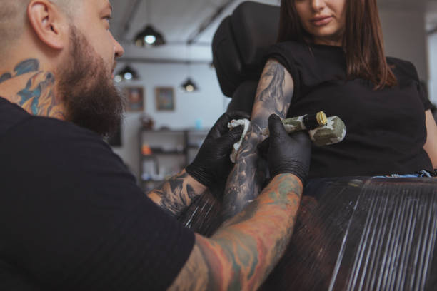 istock Professional tattoo artist working at his studio 1183052224