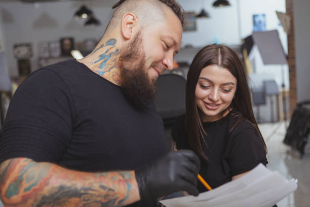 istock Professional tattoo artist working at his studio 1183052303