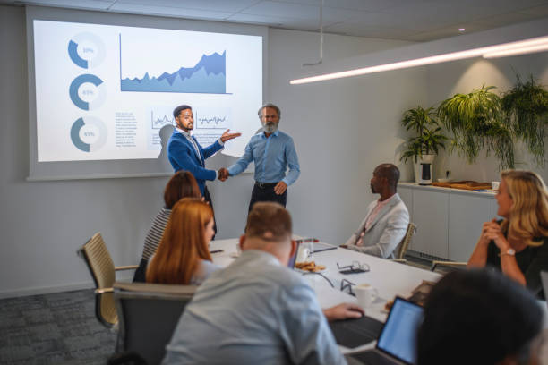 istock African Businessman Introducing Mature Guest Speaker 1183053274