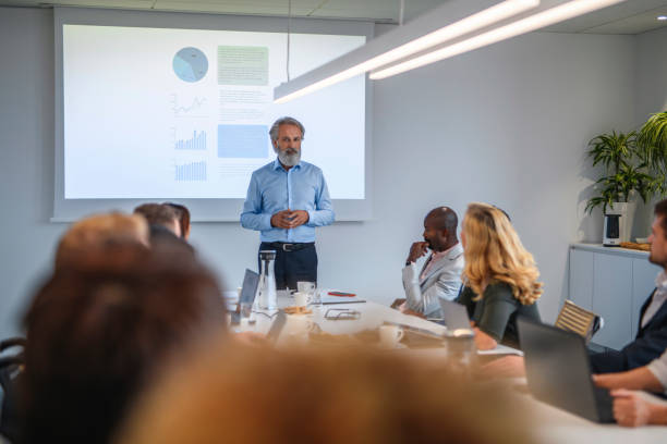 istock Executives Listening to Presentation in Conference Room 1183053280
