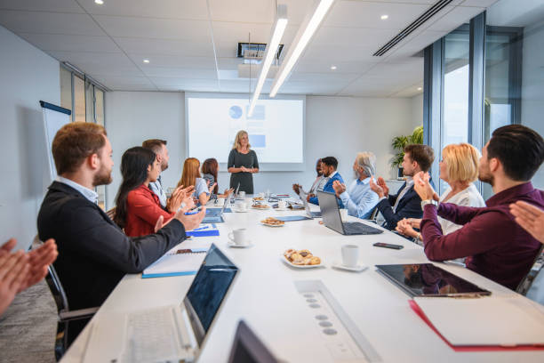 istock Female CEO Receiving Warm Reception from Colleagues 1183053286