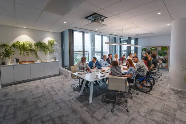 Photo of Executive Team Sitting at Conference Table in Board Room