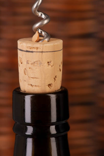istock Opening a wine bottle with a cork screw in a restaurant 1183053496