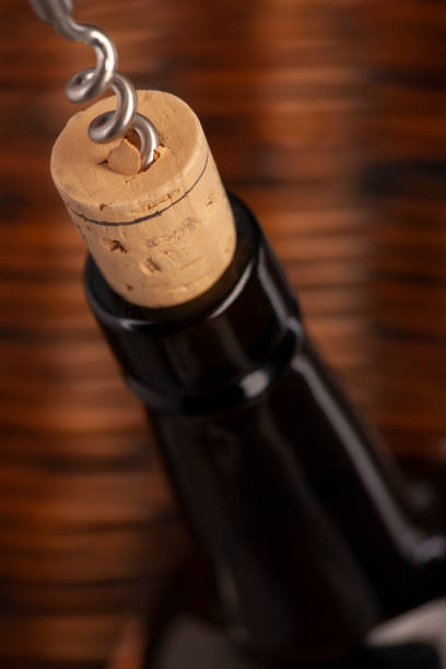 istock Opening a wine bottle with a cork screw in a restaurant 1183053519