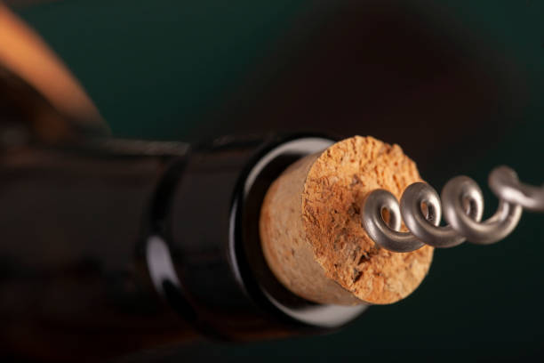 istock Opening a wine bottle with a cork screw in a restaurant 1183053533