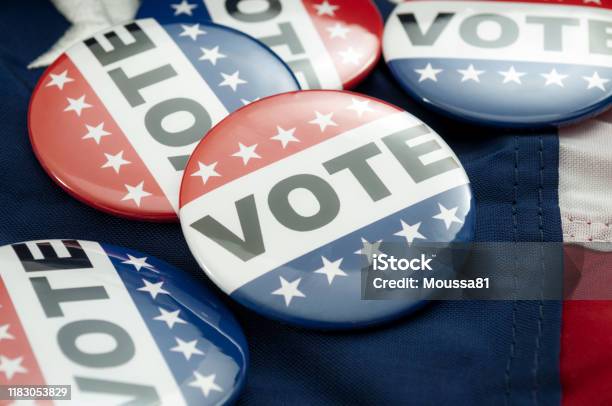 Democrat Vs Republican Poll Democratic Decision And Primary Voting Conceptual Idea With Vote Election Campaign Button Badges And The United States Of American Flag Stock Photo - Download Image Now