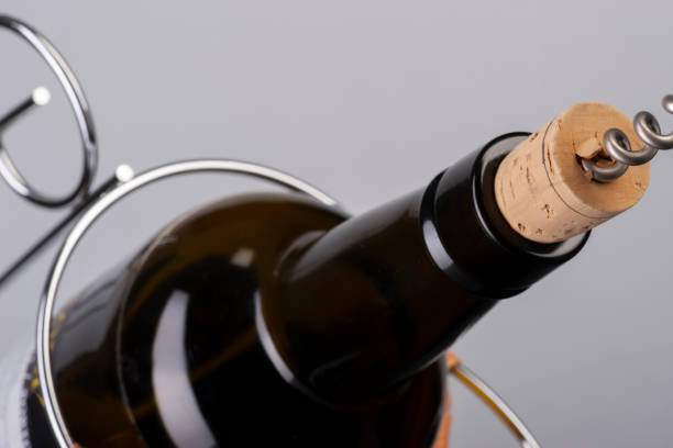istock Opening wine bottle with a corkscrew. Limited depth of field. 1183054094