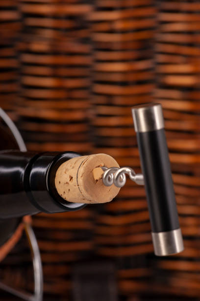 istock Opening a wine bottle with a cork screw in a restaurant 1183054771