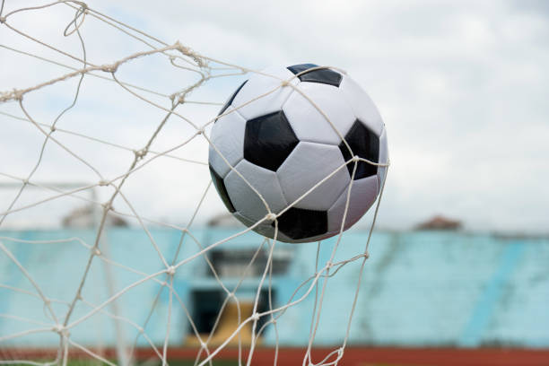 istock Soccer ball hitting the net 1183054906