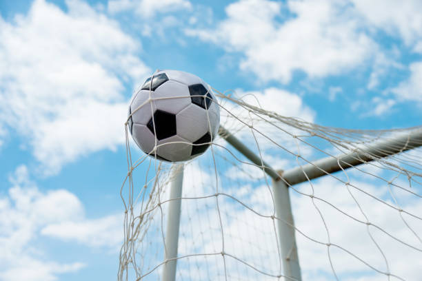 istock Soccer ball hitting the net 1183054972