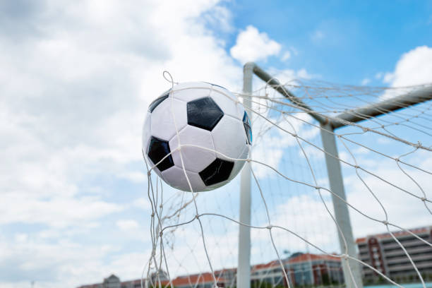 istock Soccer ball hitting the net 1183055116