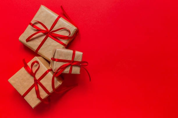 istock Christmas background with decorations and gift boxes on red background 1183055137