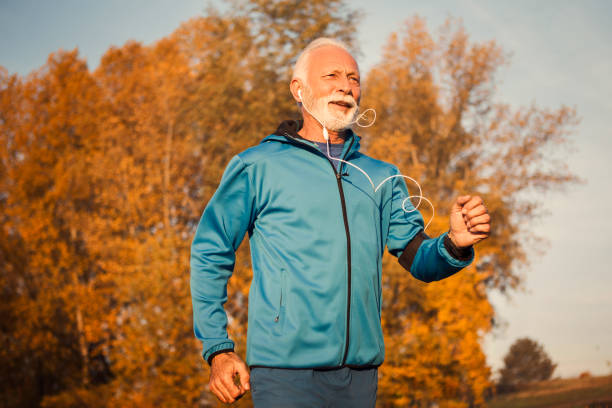 istock Senior Caucasian man jogging in park 1183055365