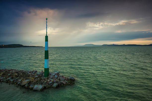 Beacon on mole in Lake Balton at stormy weather