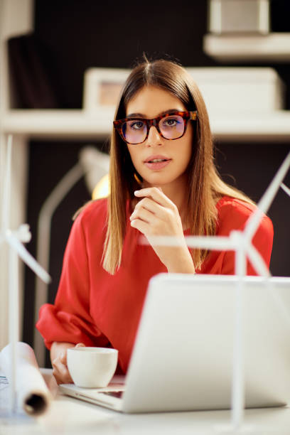istock Businesswoman drinking coffee in office. 1183056141