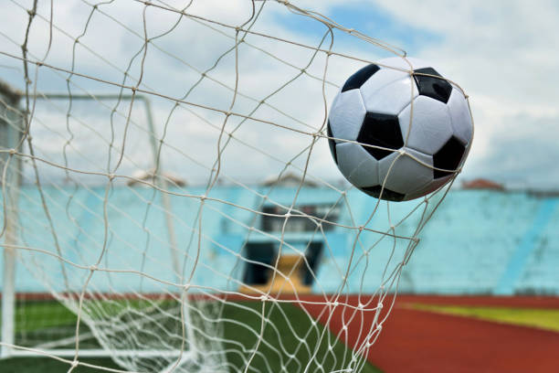 istock Soccer ball hitting the net 1183056272