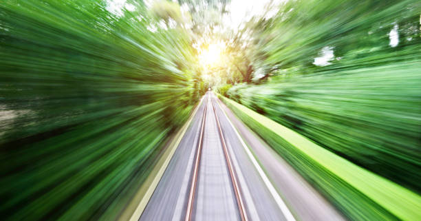 blurred railway track and green bush - non urban scene railroad track station day imagens e fotografias de stock