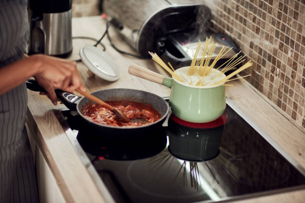 istock Woman cooking dinner. 1183060816