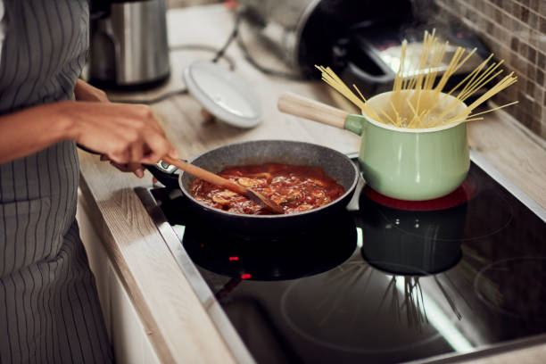 istock Woman cooking dinner. 1183061043