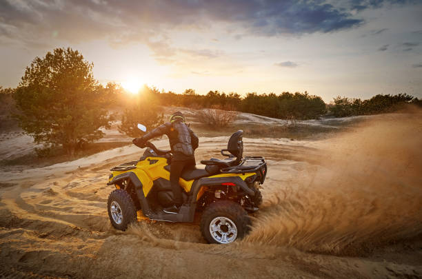 istock Racing powerful quad bike on the difficult sand in the summer. 1183061175