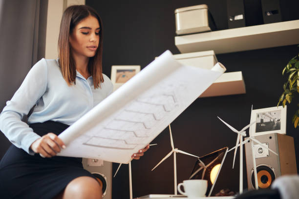 istock Businesswoman looking at plans. 1183061224