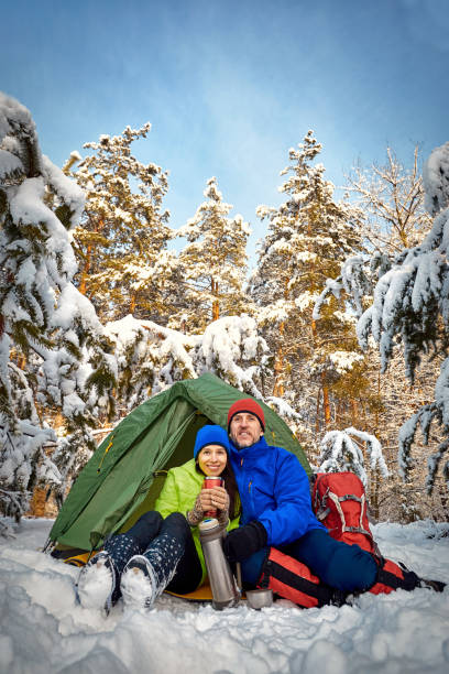 istock Walk through the winter forest with a backpack and tent. 1183061914
