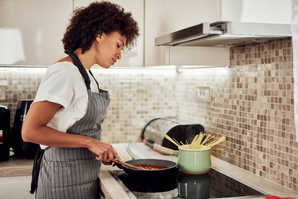 istock Woman cooking dinner. 1183062478