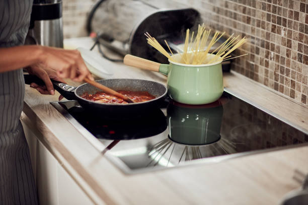 istock Woman cooking dinner. 1183062667