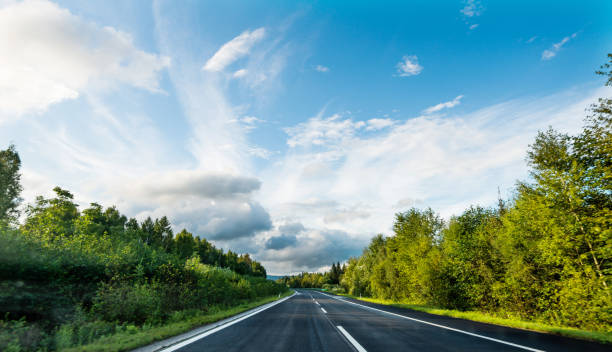 istock Empty country road and cloudy sky 1183063728