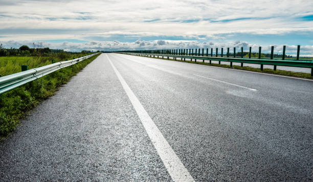 istock Empty country road and cloudy sky 1183063860