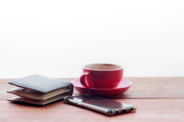 istock Smartphone with empty copy space and black wallet on wooden table. 1183065910
