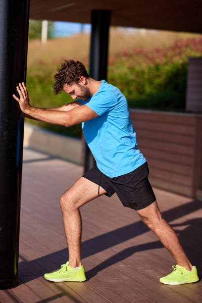 istock Man stretching and exercising in urban surroundings. 1183066001