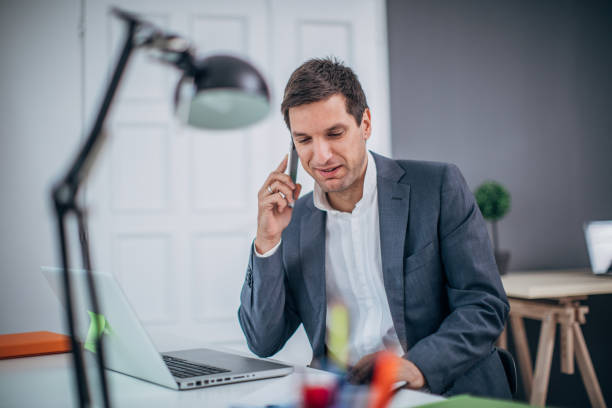 istock Businessman talking  on mobile phone in the office 1183066575