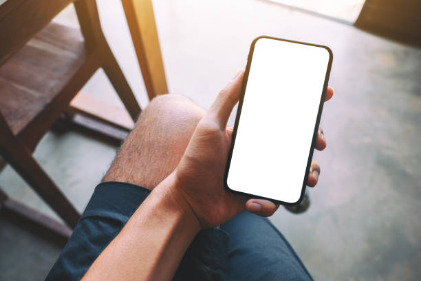istock a man holding black mobile phone with blank white screen 1183068315