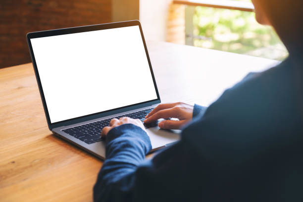 istock a woman using and typing on laptop computer keyboard with blank white desktop screen on wooden table 1183068360