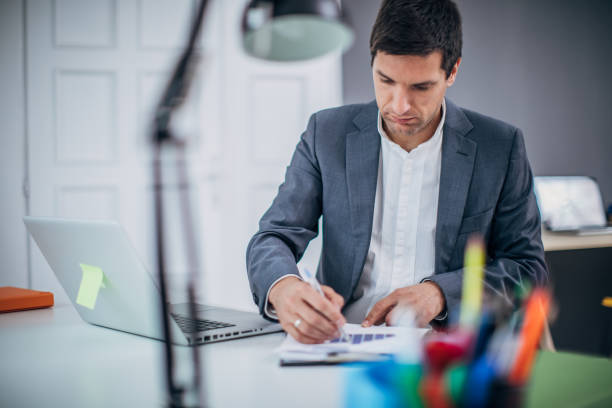 istock Businessman doing paperwork in the office 1183068835
