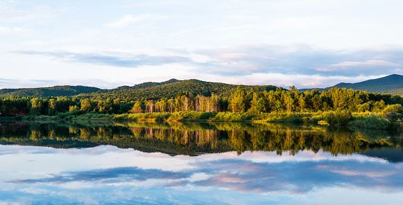 Clouds and mountains reflected in a lake