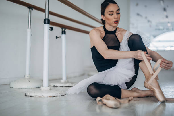 istock Beautiful ballerina preparing for practice 1183070427