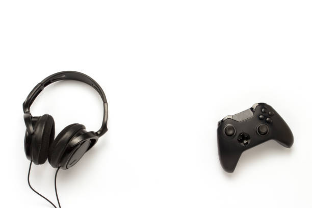 istock Black headphones and a gamepad on a white isolated background. C 1183070619